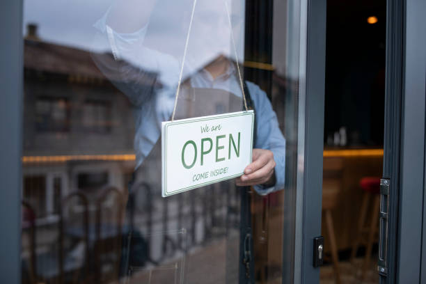 istock Open for business, owner opening his working place. 1291647631