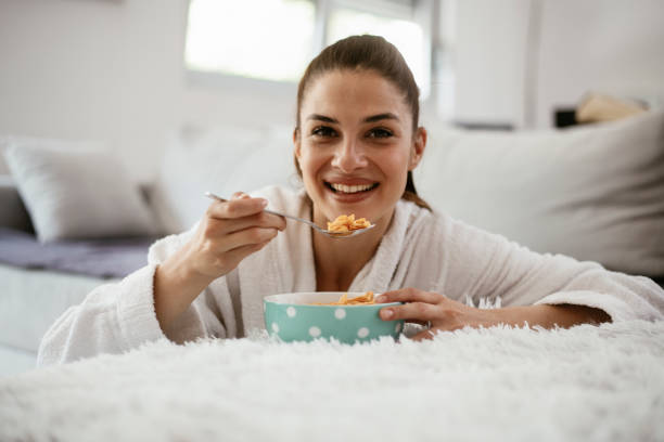 istock Young woman eating oatmeal 1291650408