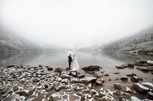 brides mountain near the lake in winter. Tender couple in love