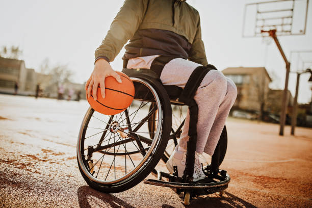 istock Man in wheelchair playing basketball 1291651171
