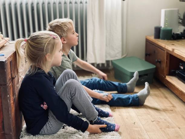 istock Brother and sister watching tv 1291651489