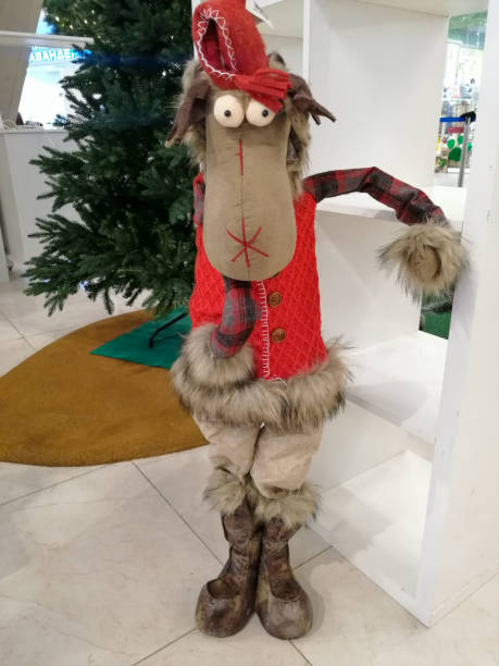 istock A soft Christmas toy under a Christmas tree. In a red vest and a cap 1291652416