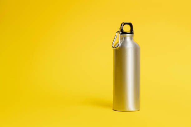 istock Metal water bottle on yellow background 1291654371