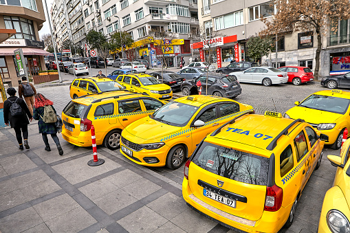 Istanbul, Turkey - February 14, 2020: Car parking on Suleyman Seba street near Poets' Park, Visnezade, Besiktas. Yellow taxi stand on a narrow street.