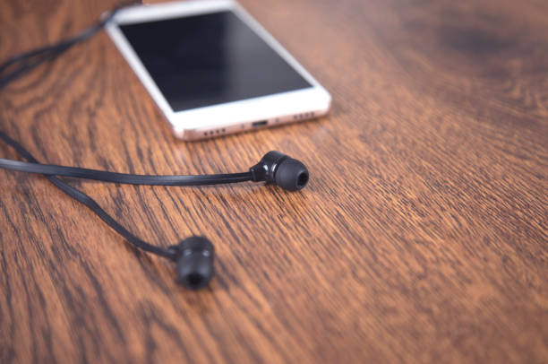 istock Earphone and smart phone on the table 1291656664