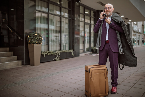 Businessman waiting for cab in front of the hotel