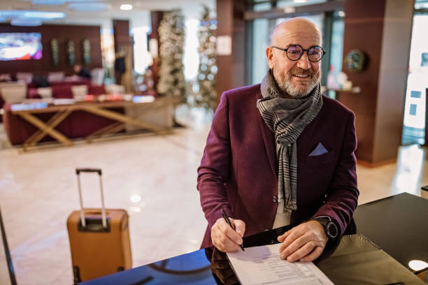 istock Senior businessman checking out from hotel 1291657973