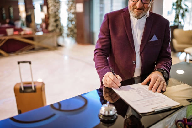 istock Senior businessman checking out from hotel 1291658196