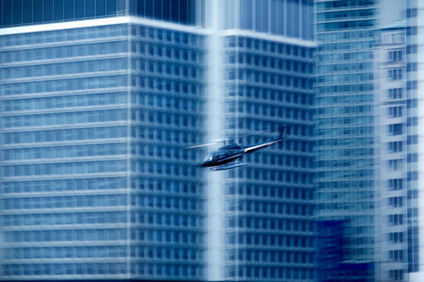 Close up private helicopter flying around buildings in Manhattan, New York