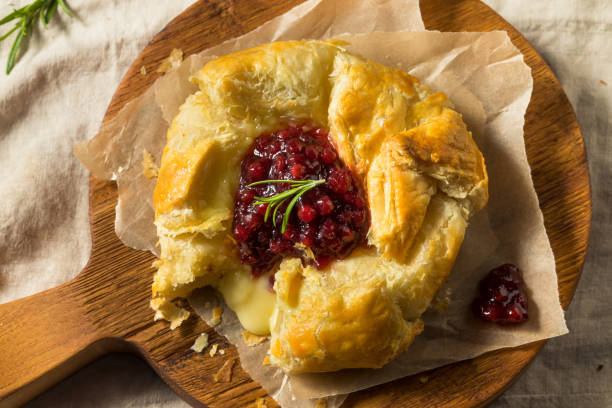 Homemade Baked Brie in Puff Pastry Homemade Baked Brie in Puff Pastry with Lingonberry brie stock pictures, royalty-free photos & images