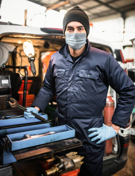 istock mechanic in front of the van with face mask 1291659716