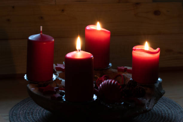 istock Red burning candles on an Advent arrangement. It is the third Advent. Christmas is coming soon. 1291660280
