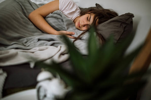 istock Young woman sleeping in bedroom 1291660983
