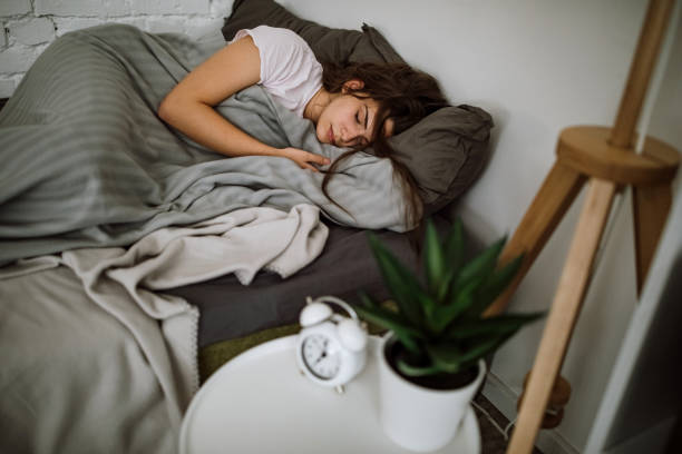 istock Young woman sleeping in bedroom 1291661669