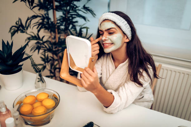 istock Young woman doing make-up in the morning at home 1291661775