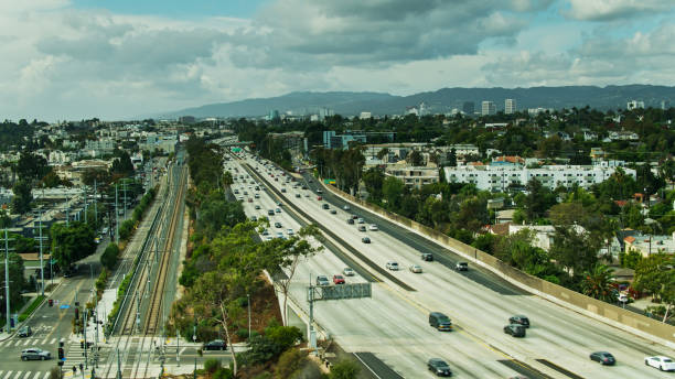 istock Light Rail Tracks Alongside I-10 in Los Angeles - Drone Shot 1291661967