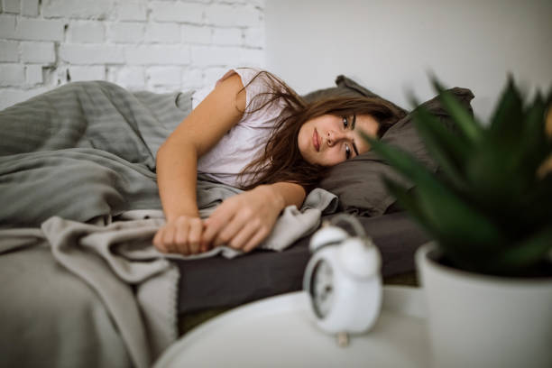 mujer dormida relajada - sleeping insomnia alarm clock clock fotografías e imágenes de stock