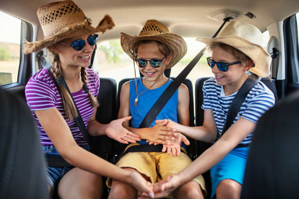 istock Kids playing games while travelling by car 1291665080
