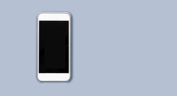 istock Top view of cell phone with black screen isolated on gray background with ample copytext space 1291666543