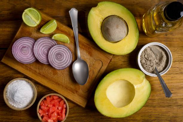 istock Avocado cut in half on a rustic pine wood table 1291666585