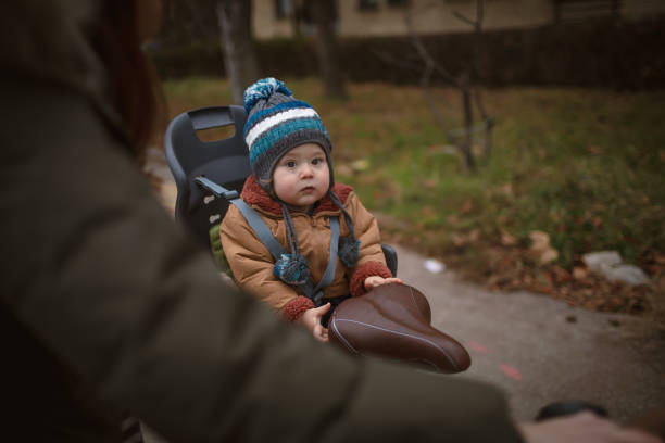 istock Baby enjoys bicycle ride with mom on a winter day 1291667849