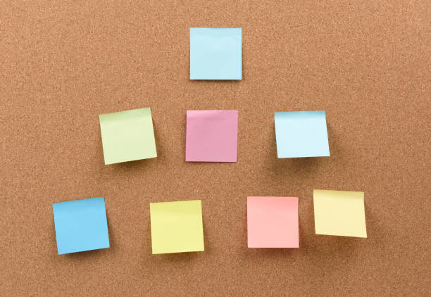 istock multicolored square sticks are glued to the brown cork texture 1291670890