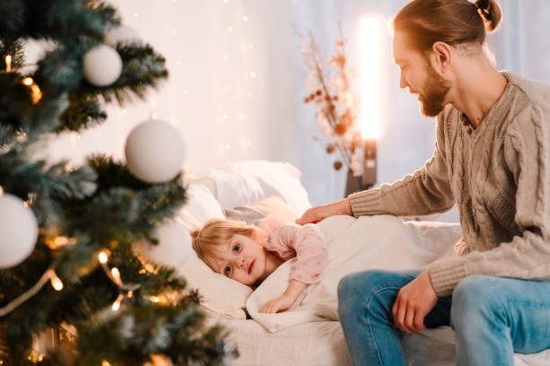 istock Dad puts his daughter to bed 1291671002