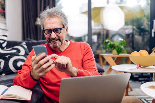 istock Portrait of a man working from home and using a smartphone 1291672048