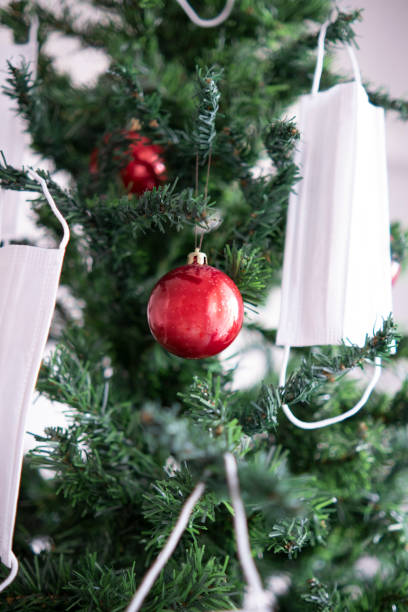 istock Protective face masks and red ornaments on the Christmas tree. 1291672830