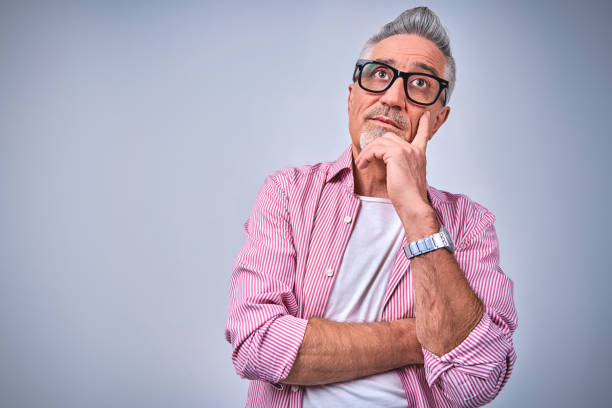 istock Attractive adult male looking up while posing in studio 1291673557