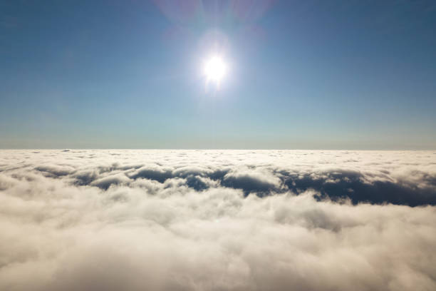 Aerial view from above of white puffy clouds.