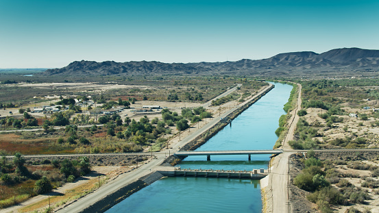 Aerial shot of the All-American Canal close to the Imperial Dam and Reservoir on the California-Arizona border. At this point, about 90% of the volume of the Colorado River is de-silted and diverted into the canal to irrigate California's Imperial Valley, the most productive winter agricultural region in the United States.