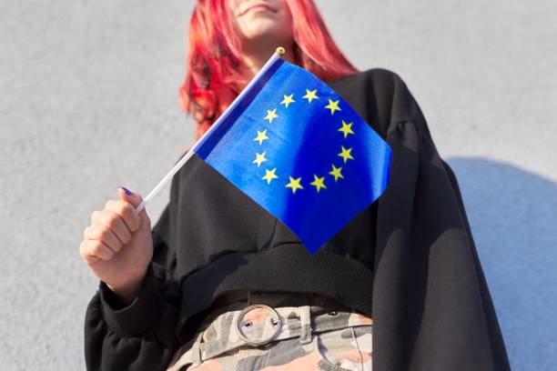 студентка-подросток с флагом ес в руке, серый открытый фон стены - flag european union flag european community european culture стоковые фото и изображения