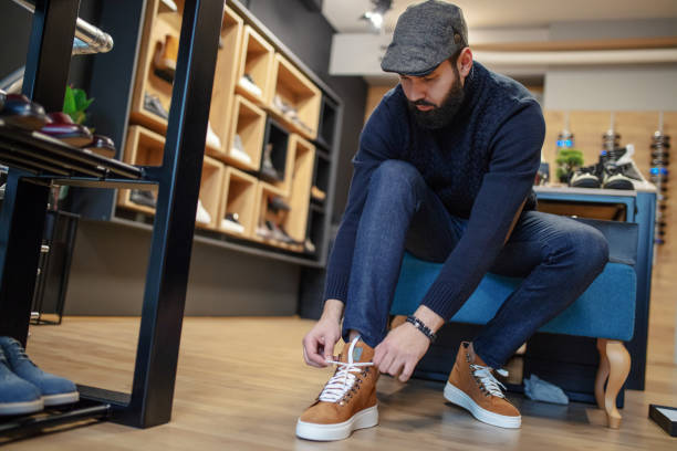 Young man shopping shoes Young man shopping shoes shoe store stock pictures, royalty-free photos & images