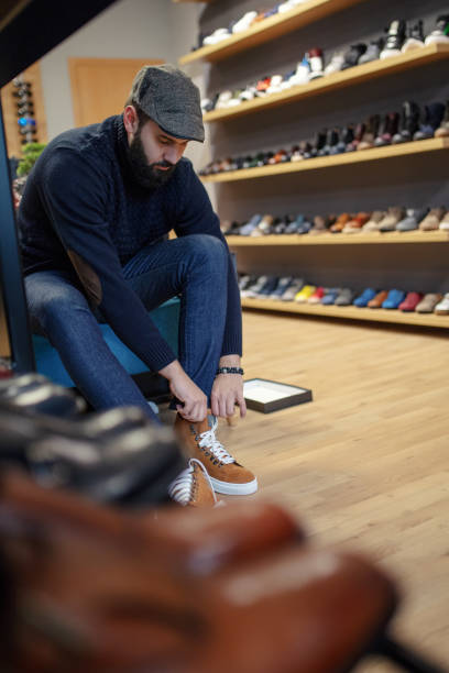 istock Young man shopping shoes 1291678627