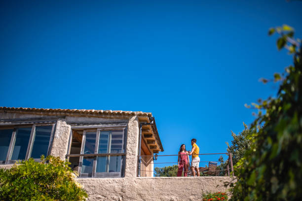 istock Young Male and Female Talking on Second Floor Home Terrace 1291681248