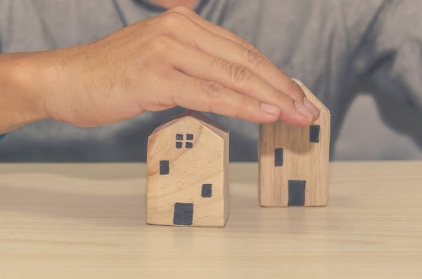 istock man with a hand to protect the house 1291681846