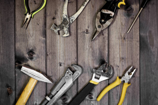 istock Set of assorted work carpentry and locksmith tools on a dark wooden background with copy space. 1291682159