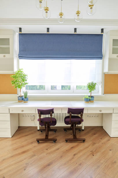 istock Home office, workplace for two people, desk near the window 1291685234