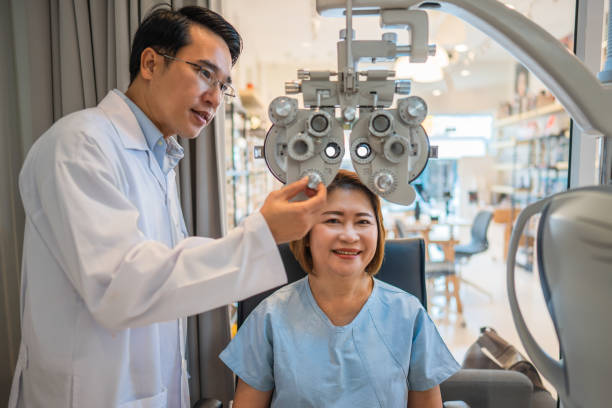 istock optometrist using phoropter to check eyesight value for client eyeglasses in optical store 1291686526