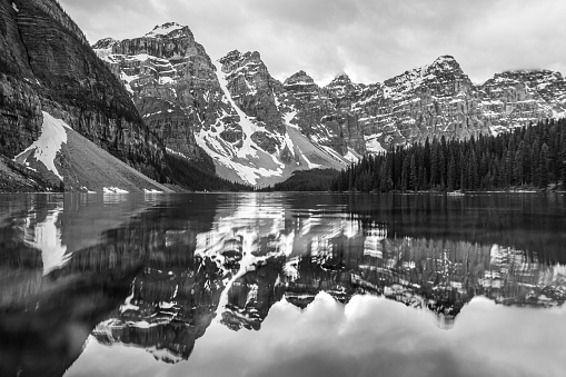 A black and white photo of Moraine Lake in Lake Louise, Alberta, Canada on a moody morning