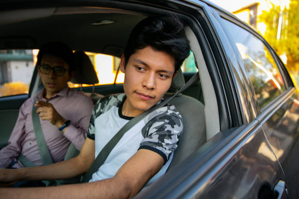 istock Learning to drive. Two young men in a driving session 1291688331