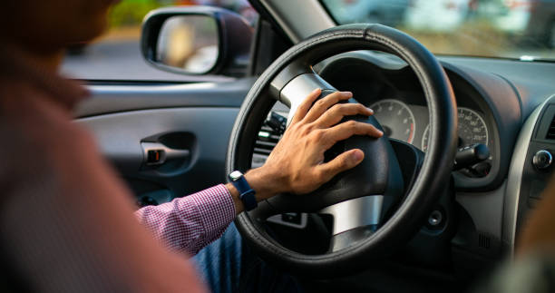 istock Man driving his car on a street 1291688370