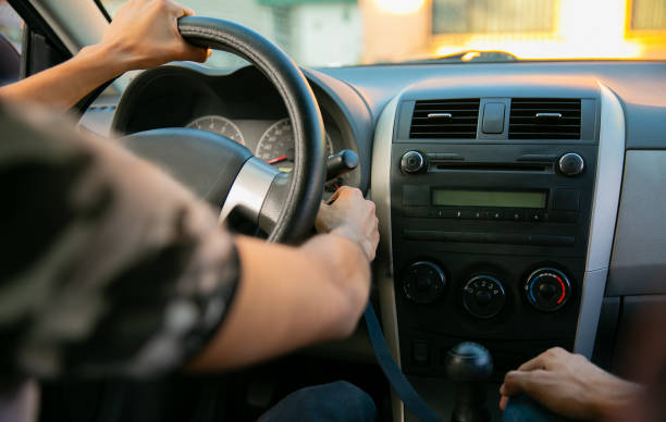 istock Learning to drive. Two young men in a driving session 1291688373