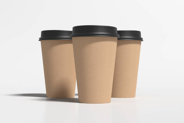 istock Three cardboard take away coffee paper cups mock up with black lids on white background. 1291690043
