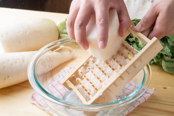 istock Grating daikon radish with traditional japanese bamboo grator 1291690049
