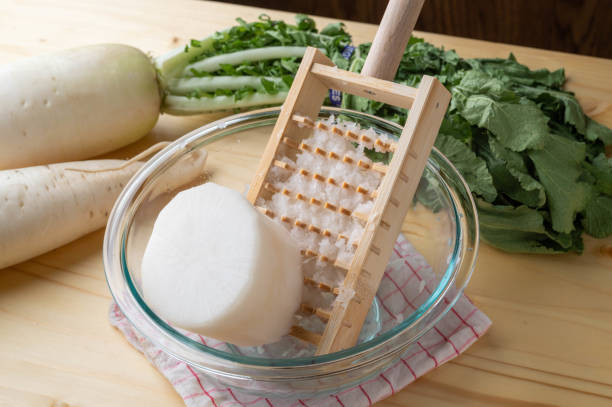 istock Grating daikon radish with traditional japanese bamboo grator 1291690054