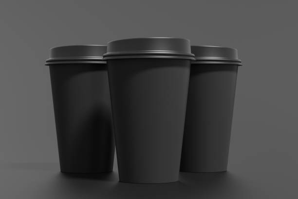 istock Three black take away coffee paper cups mock up with black lids on black background. 1291690055