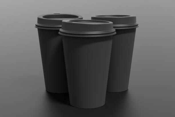 istock Three black take away coffee paper cups mock up with black lids on black background. 1291690082