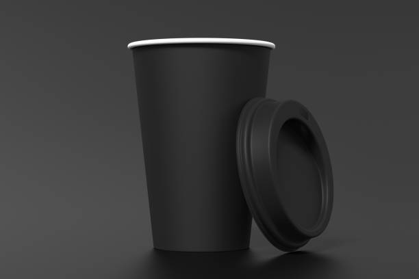 istock Black take away coffee paper cup mock up with opened black lid on black background. 1291690651